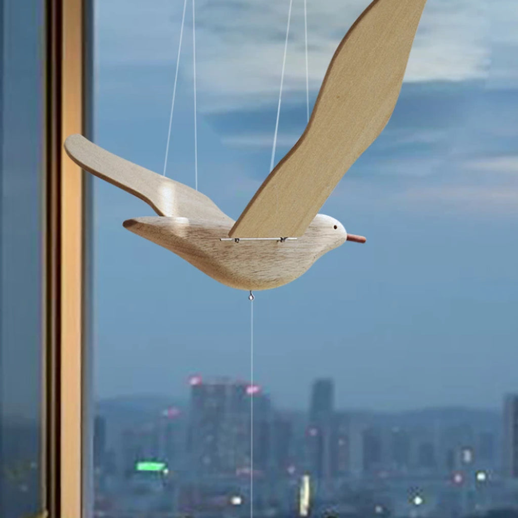 Close view of the pale wood seagull body, articulated wings, and suspension cords.